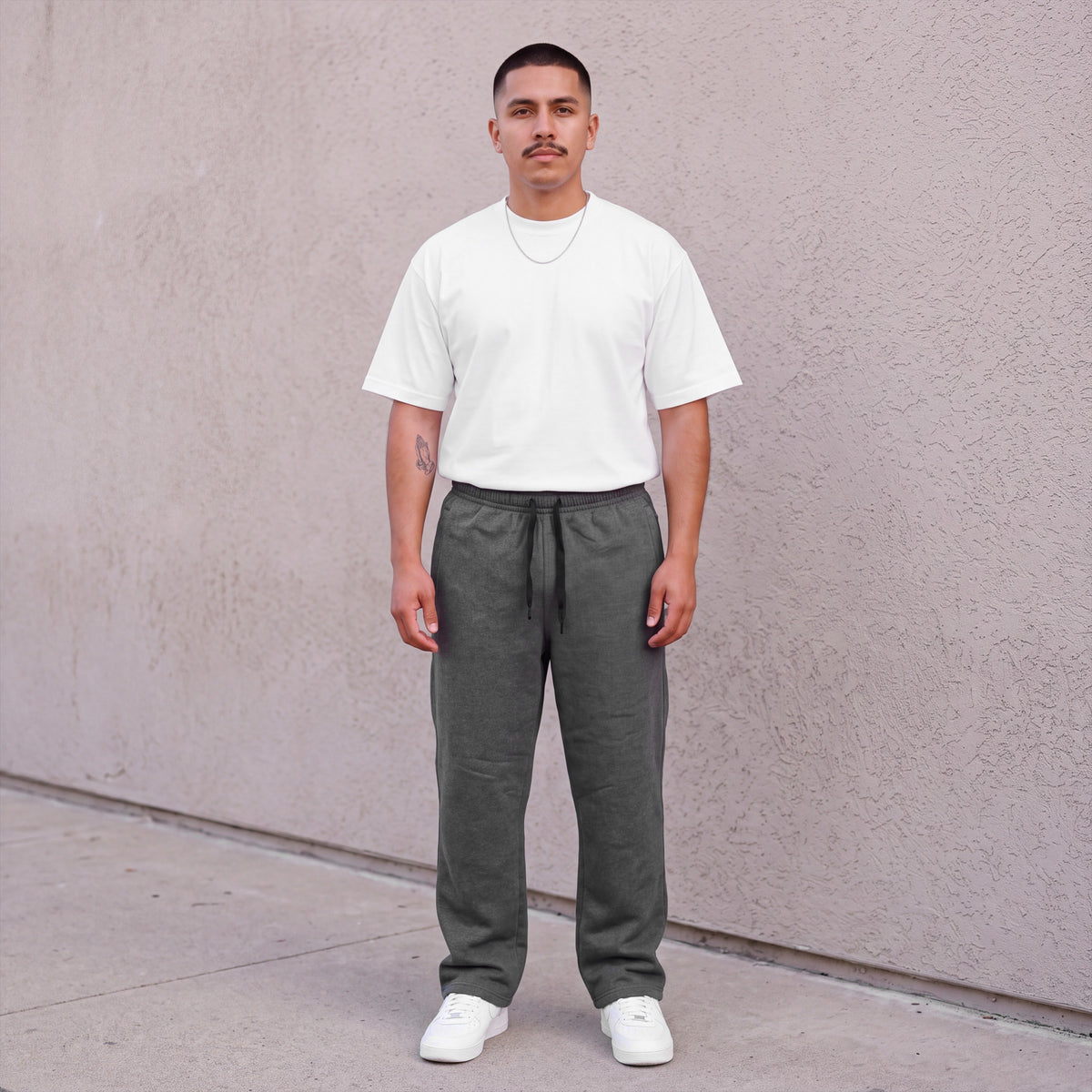 Model wearing Pro Club Men's Comfort Fleece Pants in Charcoal