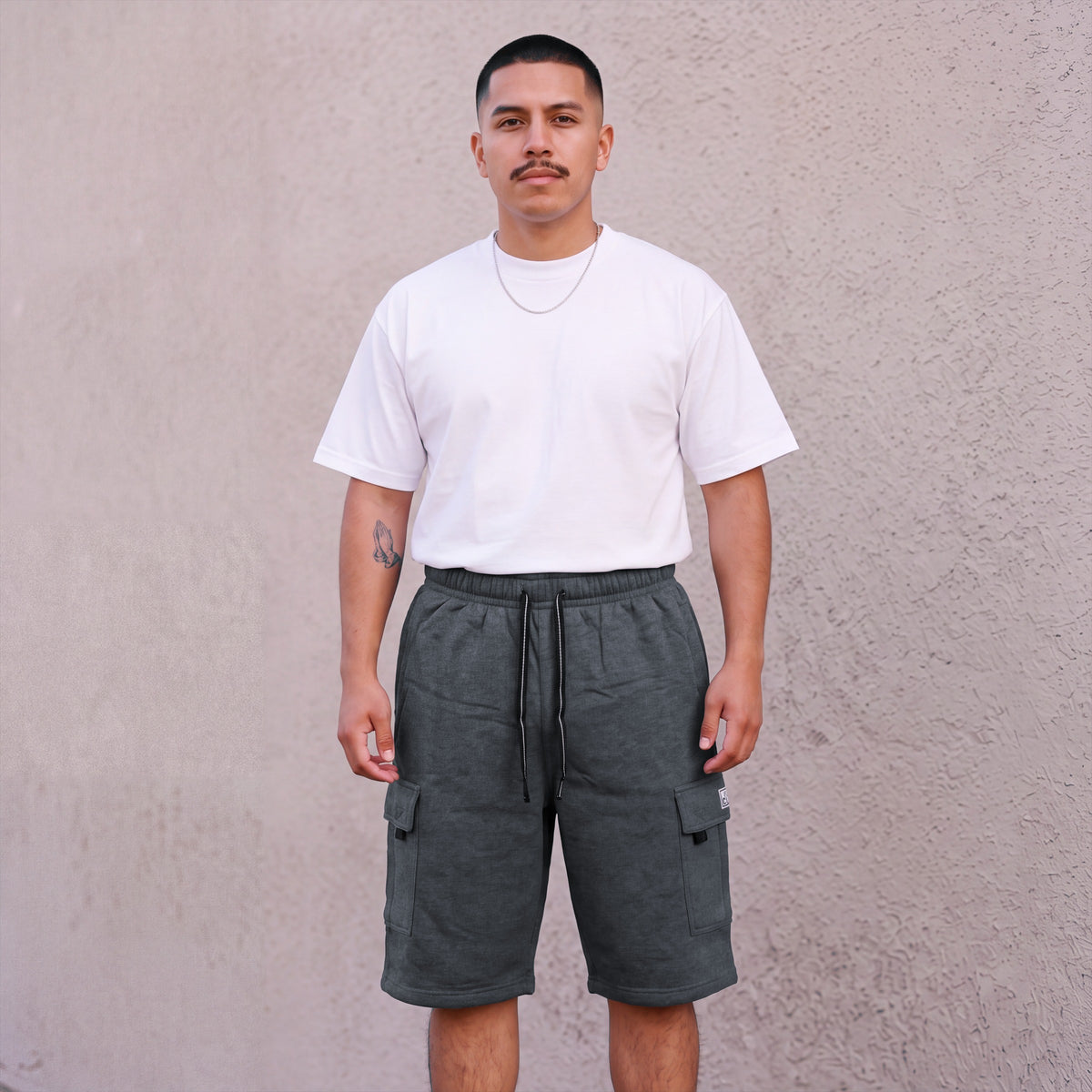 Model wearing Pro Club Men's Fleece Cargo Shorts in Charcoal