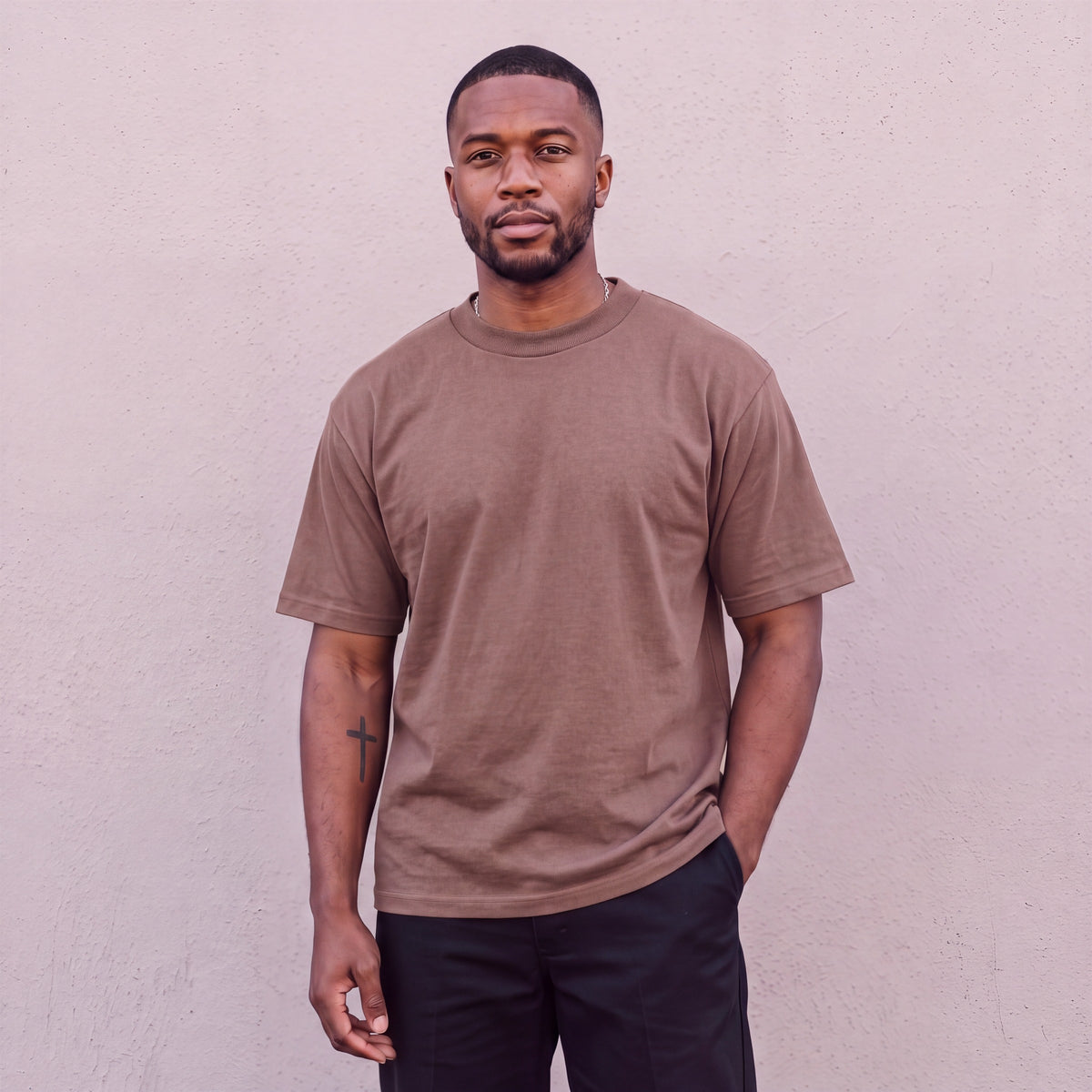 Model wearing Pro Club Men's Heavyweight Cotton Short Sleeve Crew Neck T-Shirt in Brown