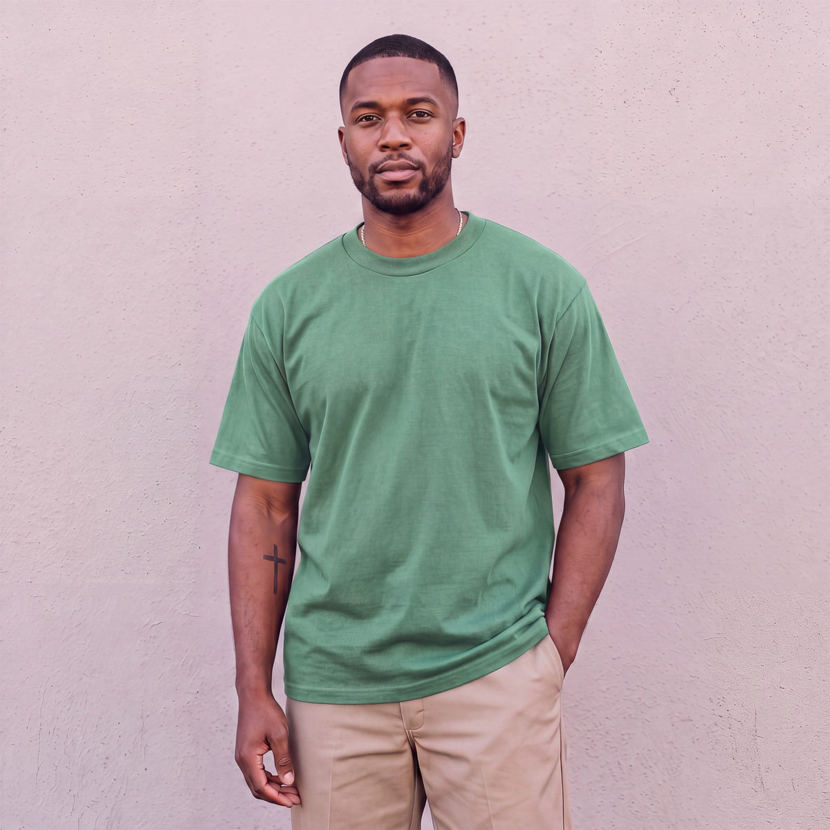 Model wearing Pro Club Men's Heavyweight Cotton Short Sleeve Crew Neck T-Shirt in Forest Green