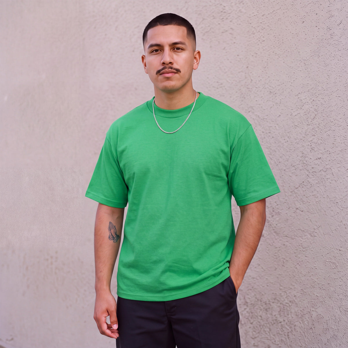 Model wearing Pro Club Men's Heavyweight Cotton Short Sleeve Crew Neck T-Shirt in Kelly Green
