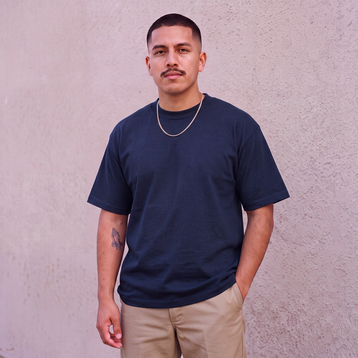 Model wearing Pro Club Men's Heavyweight Cotton Short Sleeve Crew Neck T-Shirt in Navy
