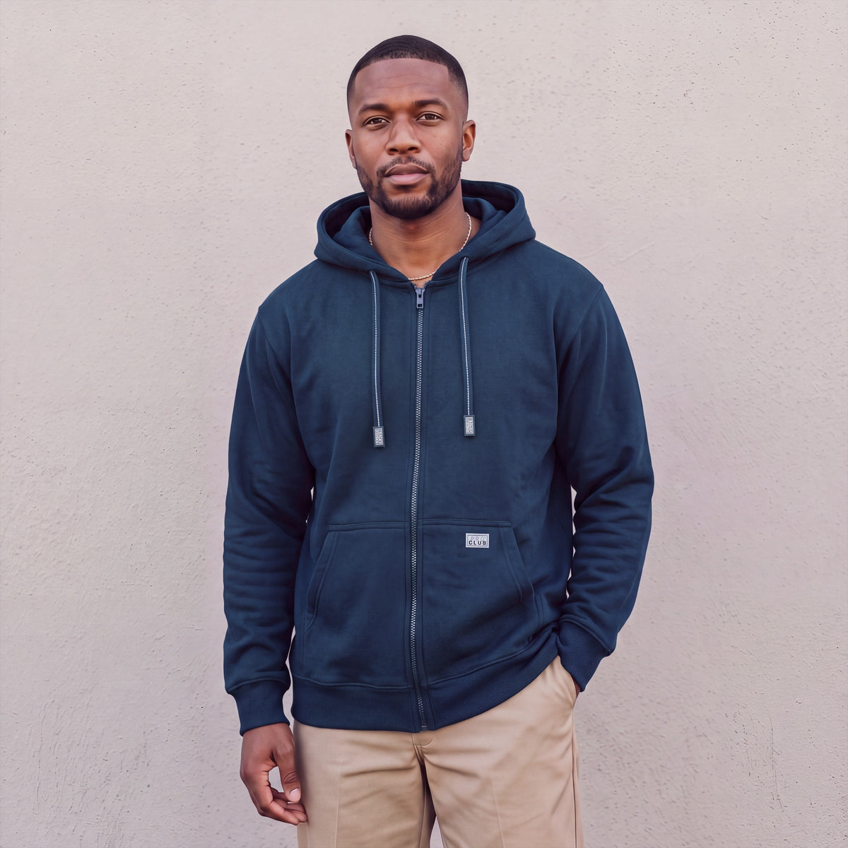 Model wearing Pro Club Men's Heavyweight Full Zip Fleece Hoodie in Navy