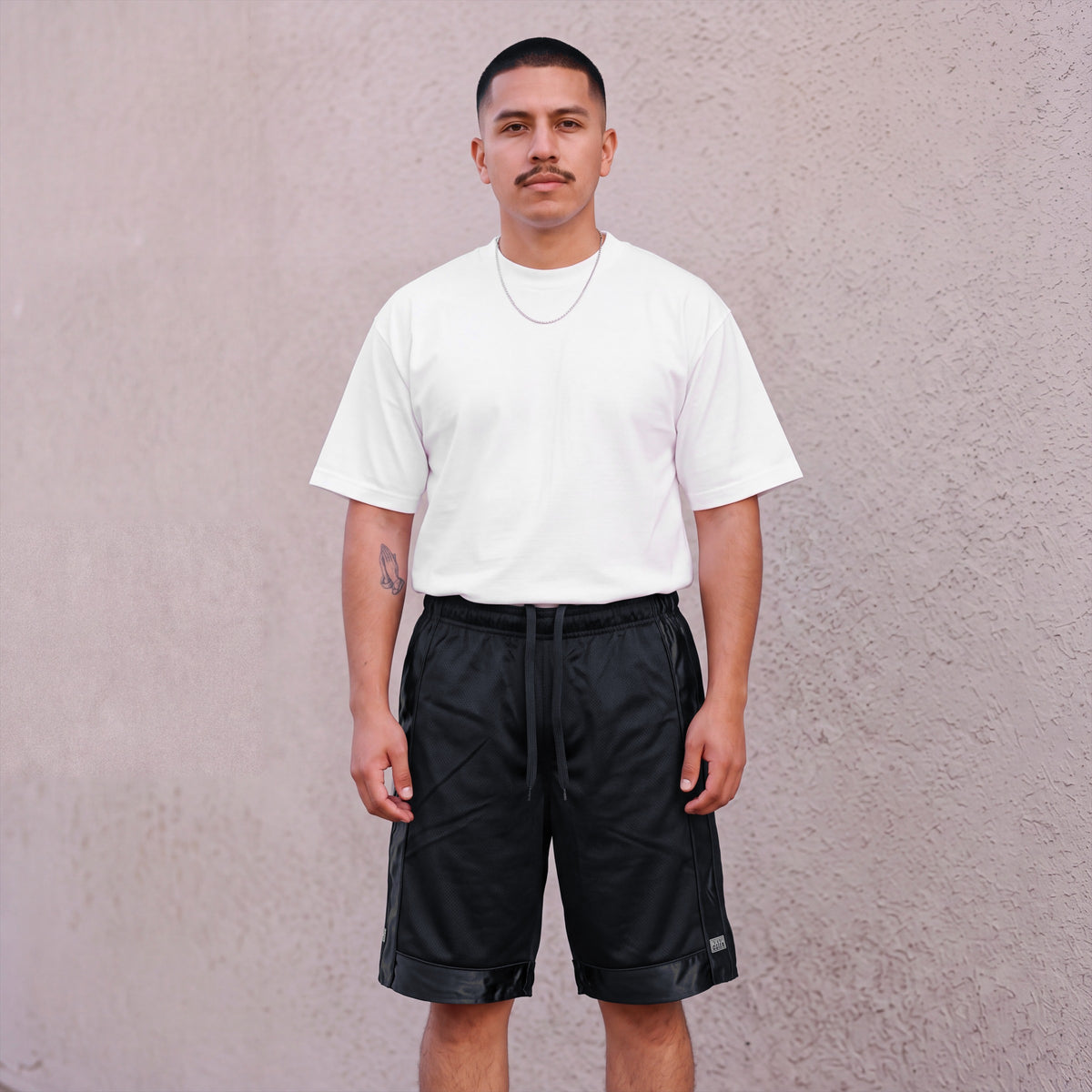 Model wearing Pro Club Men's Heavyweight Mesh Basketball Shorts in Black