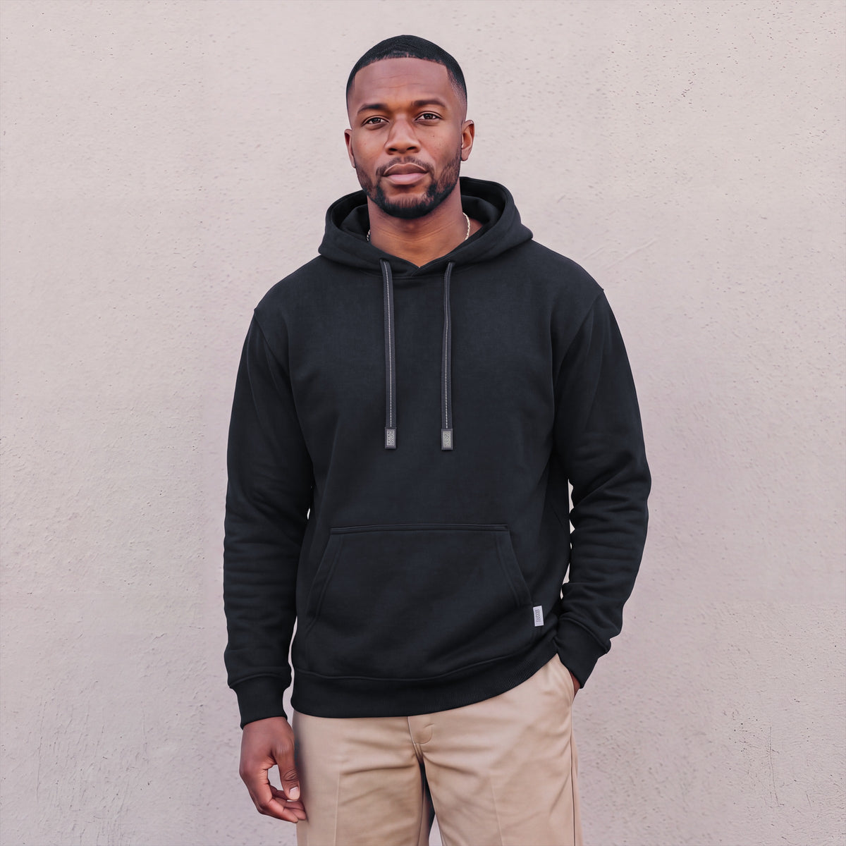 Model wearing Pro Club Men's Heavyweight Pullover Hoodie (13oz) in Black