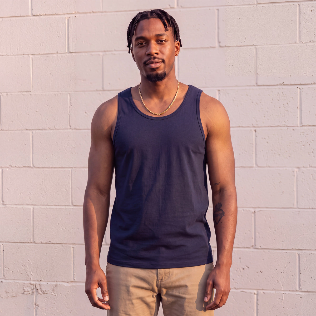 Model wearing Shaka Wear 6.0 Oz Tank Top in Navy