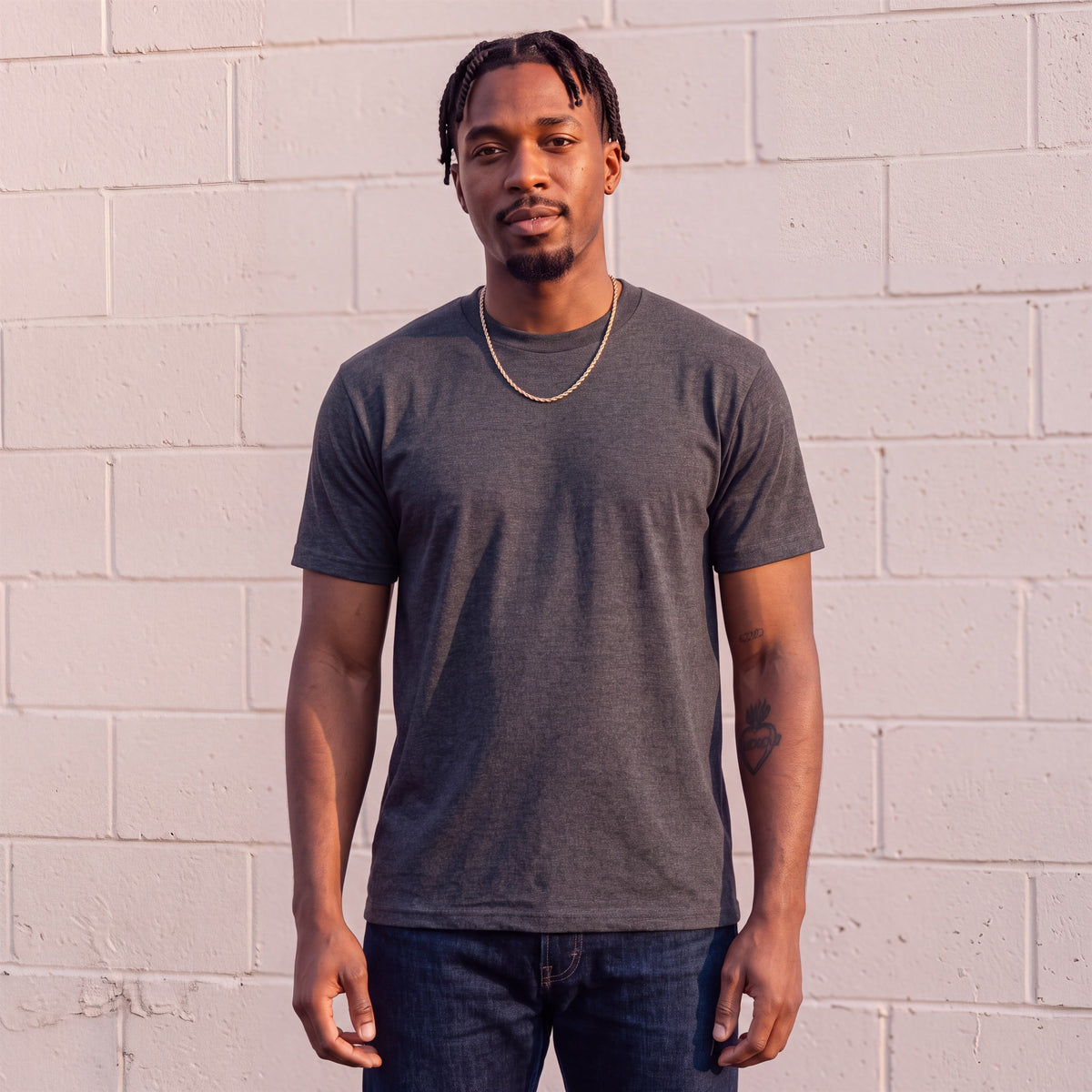 Model wearing Shaka Wear 6.0 oz Active Short Sleeve T-Shirt in Charcoal