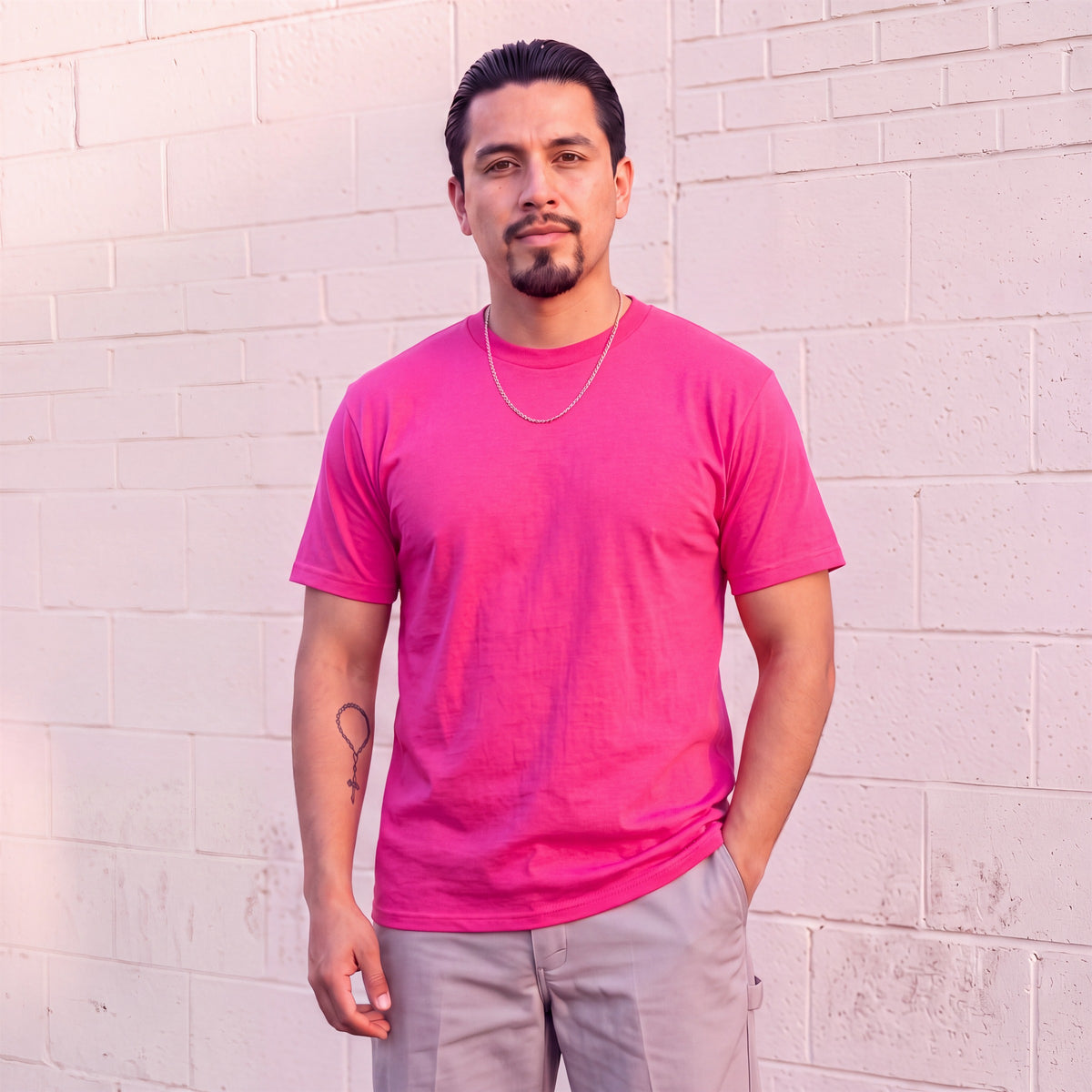 Model wearing Shaka Wear 6.0 oz Active Short Sleeve T-Shirt in Hot Pink