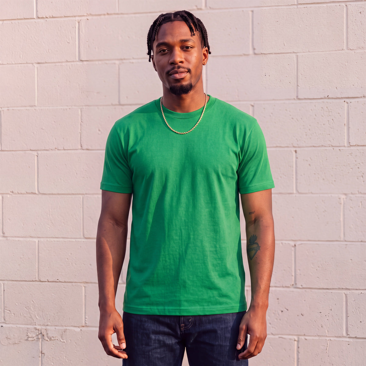 Model wearing Shaka Wear 6.0 oz Active Short Sleeve T-Shirt in Kelly Green