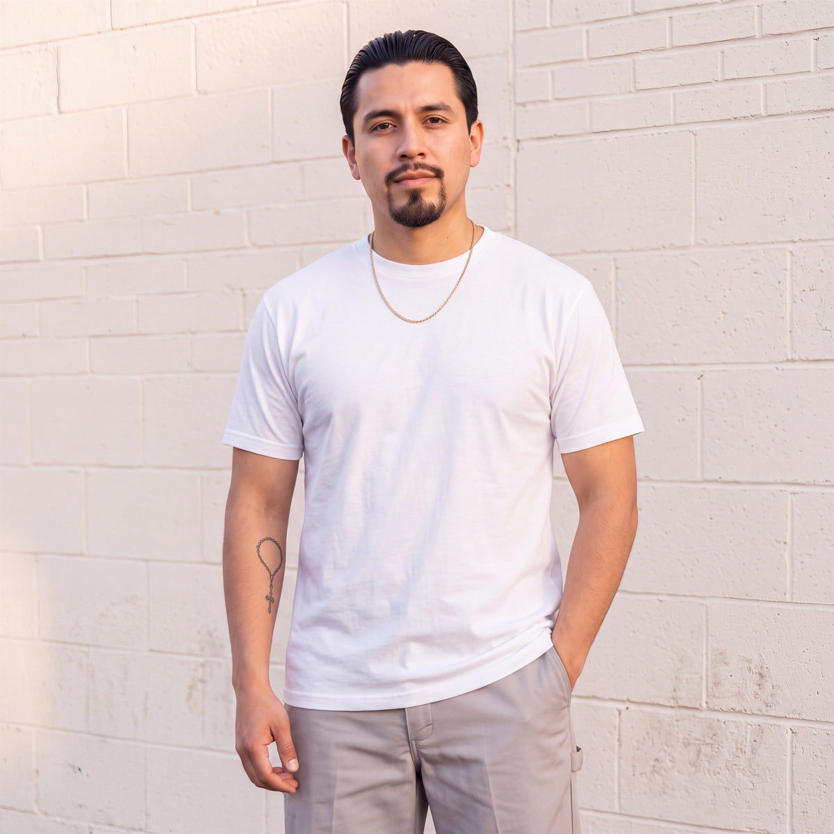 Model wearing Shaka Wear 6.0 oz Active Short Sleeve T-Shirt in White