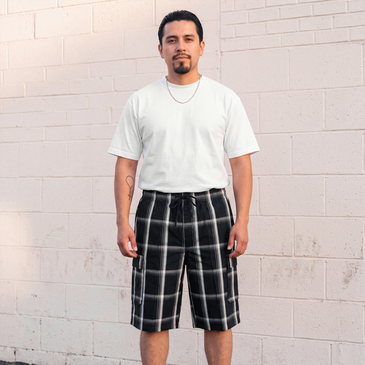 Model wearing Shaka Wear Plaid Shorts in Black