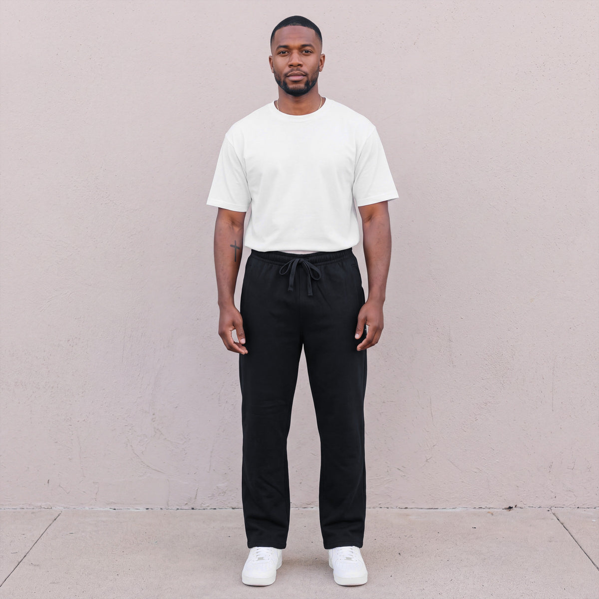 Model wearing Pro Club Men's Comfort Fleece Pants in Black