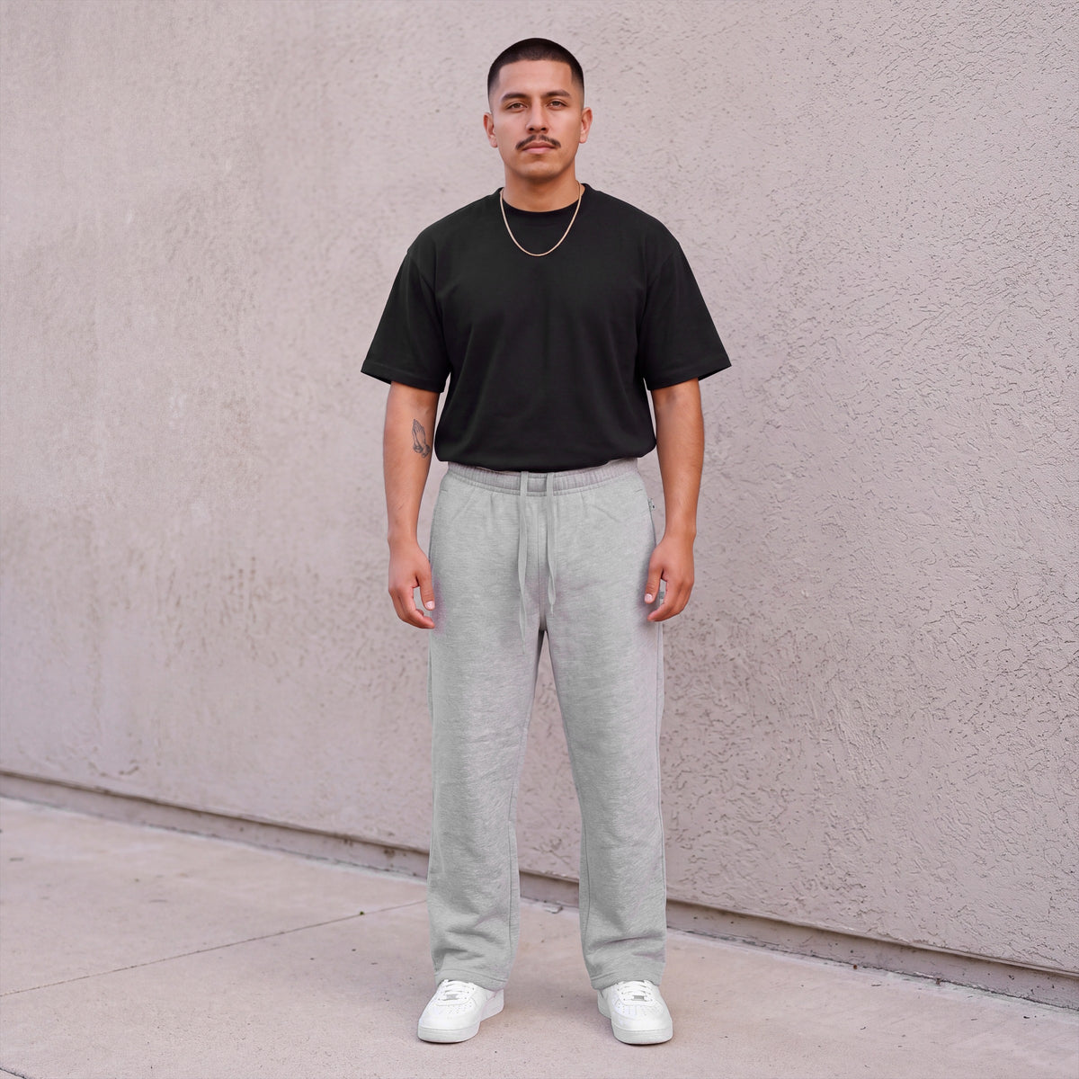 Model wearing Pro Club Men's Comfort Fleece Pants in Heather Grey