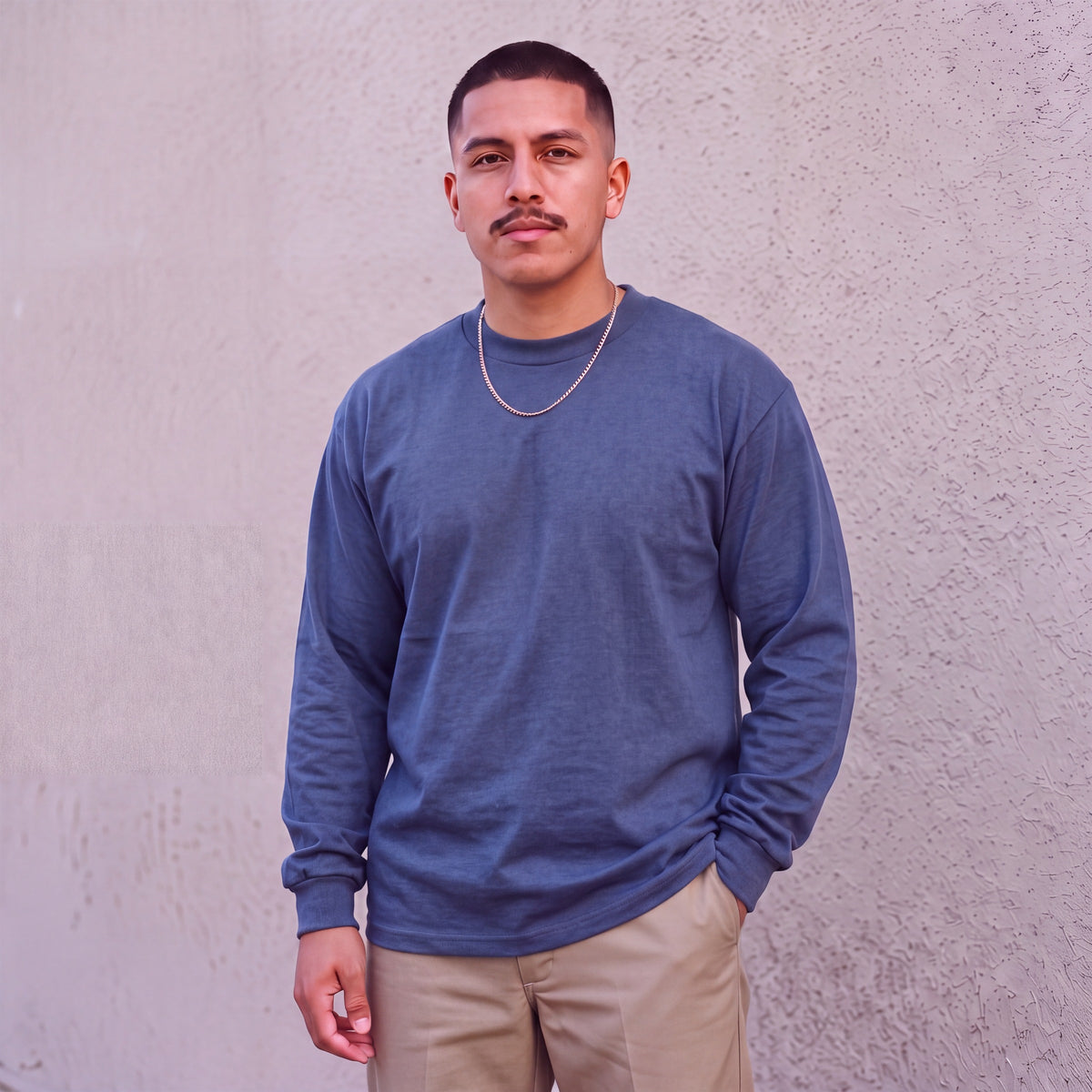 Model wearing Pro Club Men's Heavyweight Cotton Long Sleeve Crew Neck T-Shirt in Navy