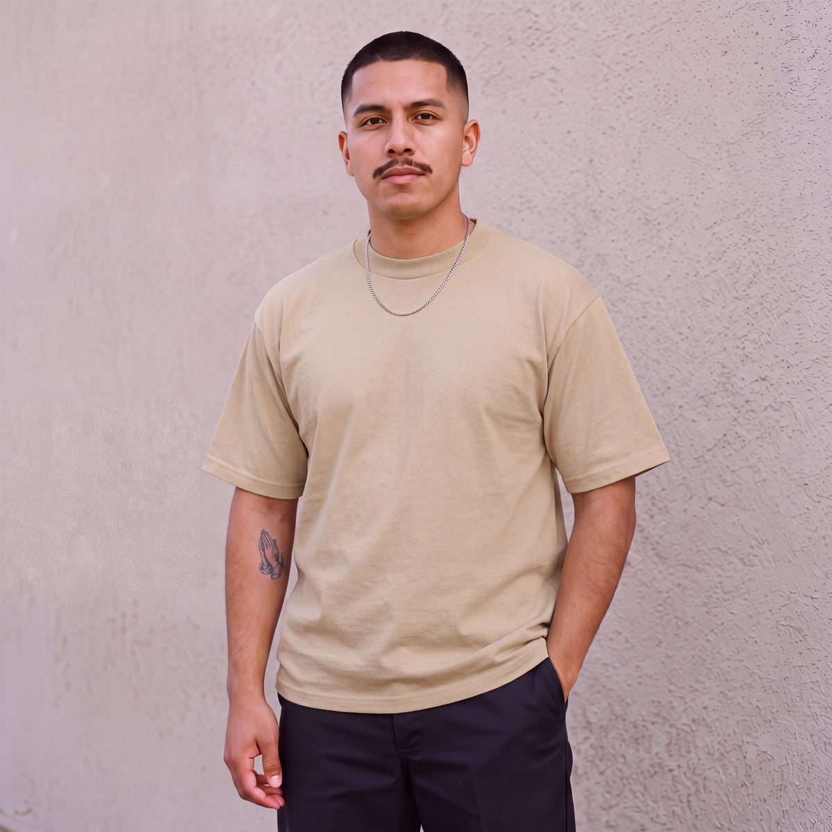 Model wearing Pro Club Men's Heavyweight Cotton Short Sleeve Crew Neck T-Shirt in Khaki