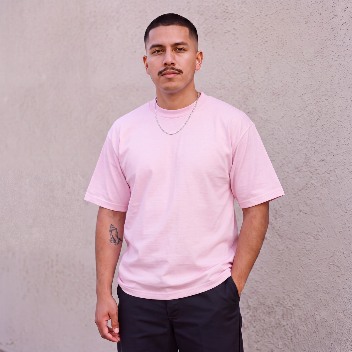 Model wearing Pro Club Men's Heavyweight Cotton Short Sleeve Crew Neck T-Shirt in Pink
