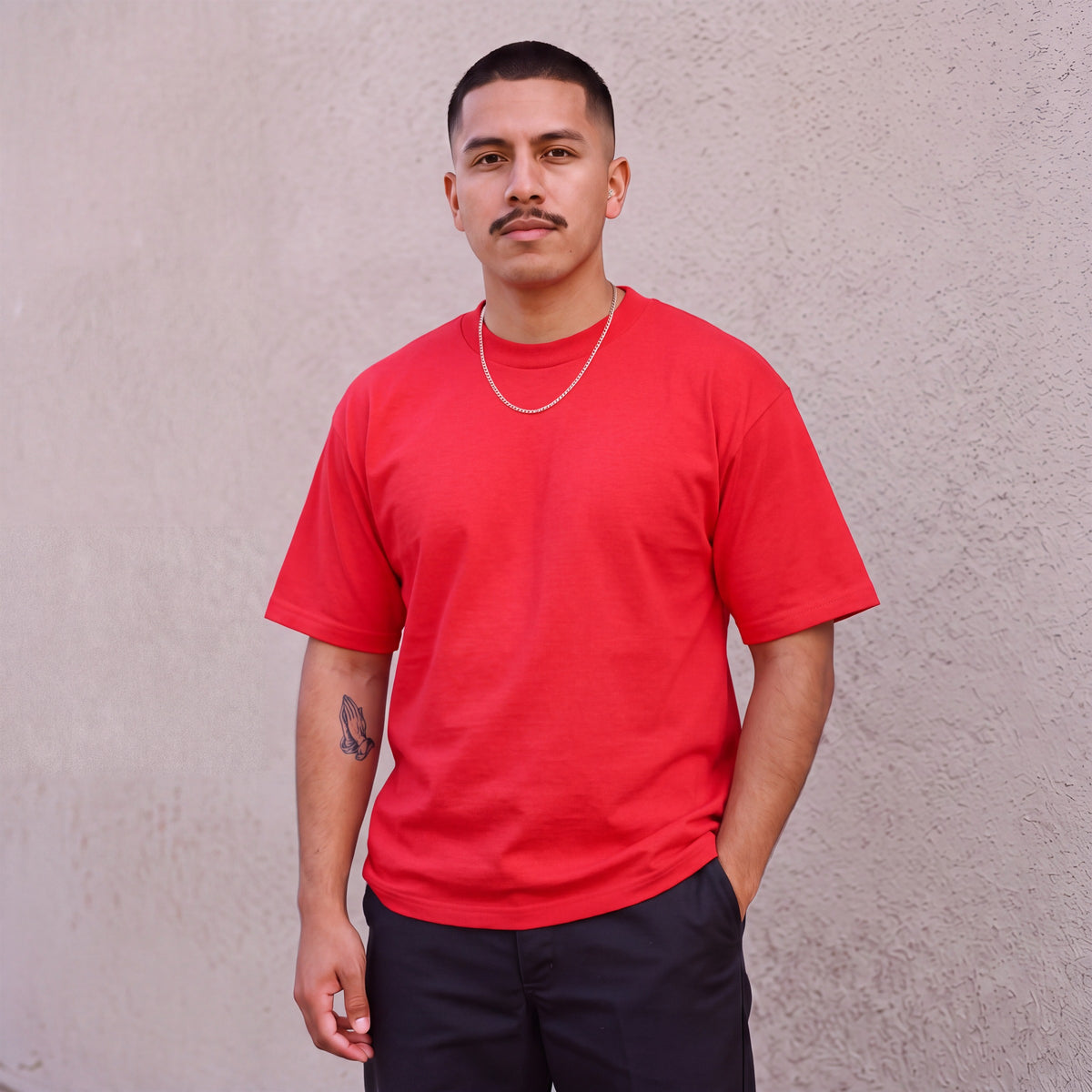 Model wearing Pro Club Men's Heavyweight Cotton Short Sleeve Crew Neck T-Shirt in Red