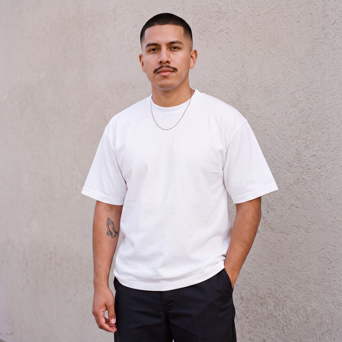 Model wearing Pro Club Men's Heavyweight Cotton Short Sleeve Crew Neck T-Shirt in White
