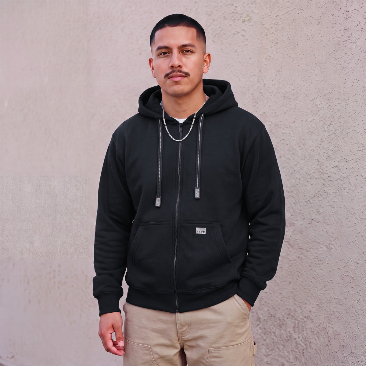 Model wearing Pro Club Men's Heavyweight Full Zip Fleece Hoodie in Black