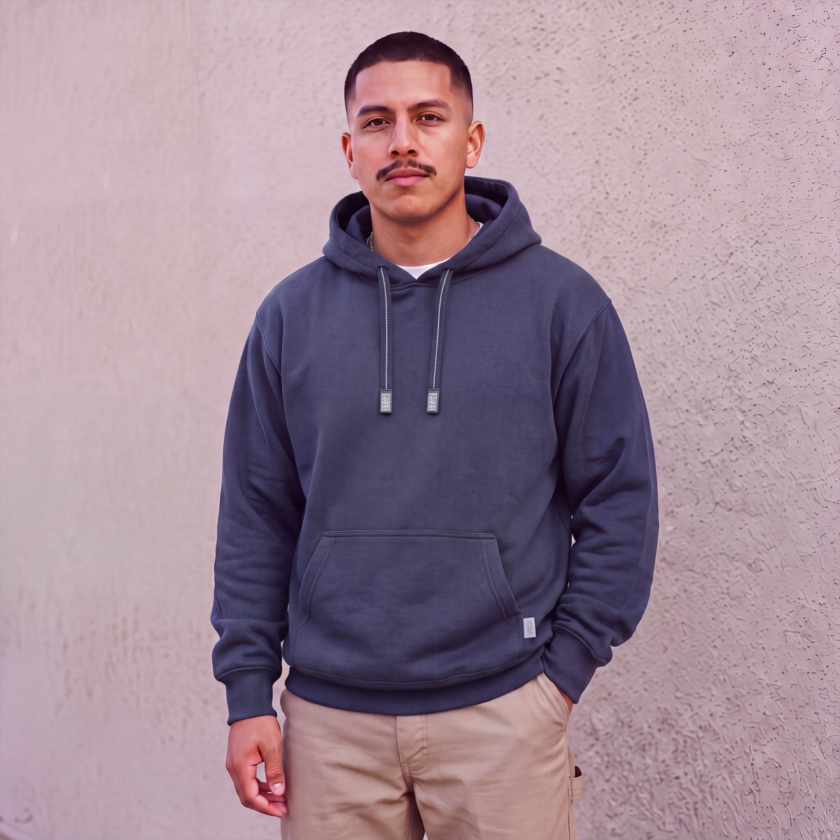 Model wearing Pro Club Men's Heavyweight Pullover Hoodie (13oz) in Navy