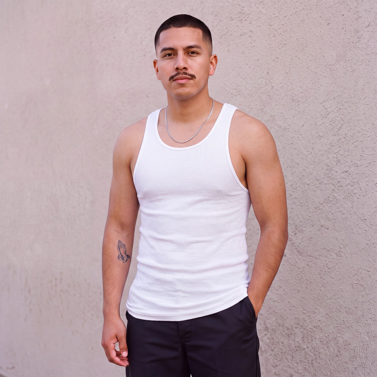Model wearing Pro Club Men's Premium Ringspun Cotton Ribbed A-Shirt (Muscle Shirt) in White
