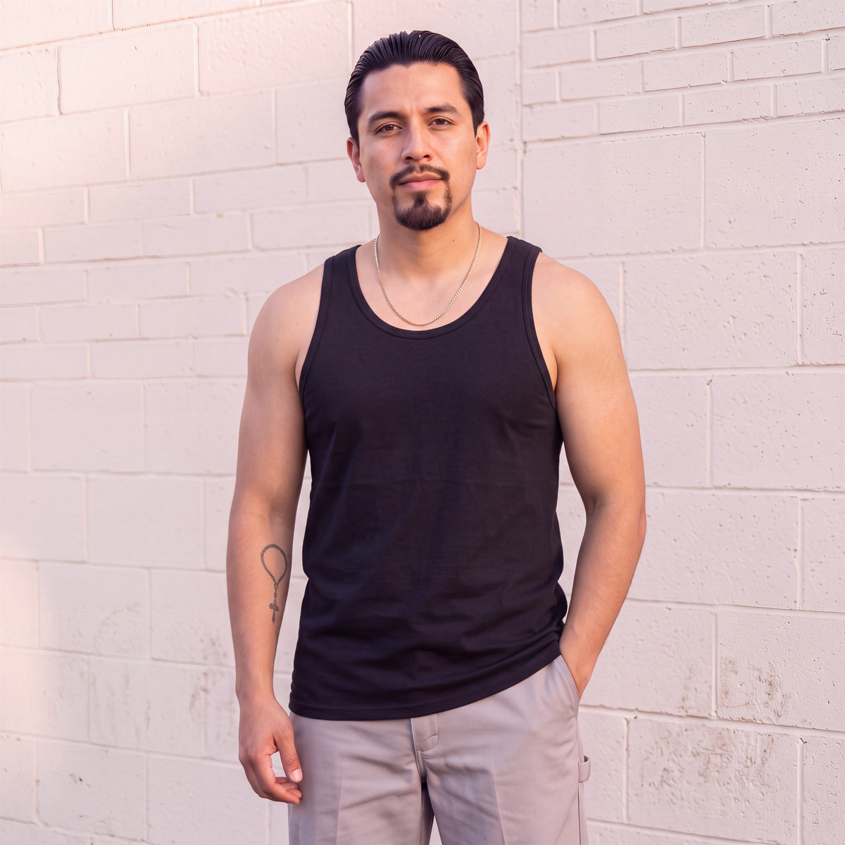 Model wearing Shaka Wear 6.0 Oz Tank Top in Black