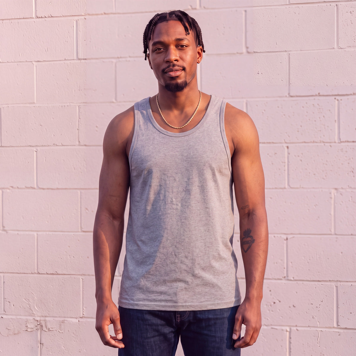 Model wearing Shaka Wear 6.0 Oz Tank Top in Heather Grey