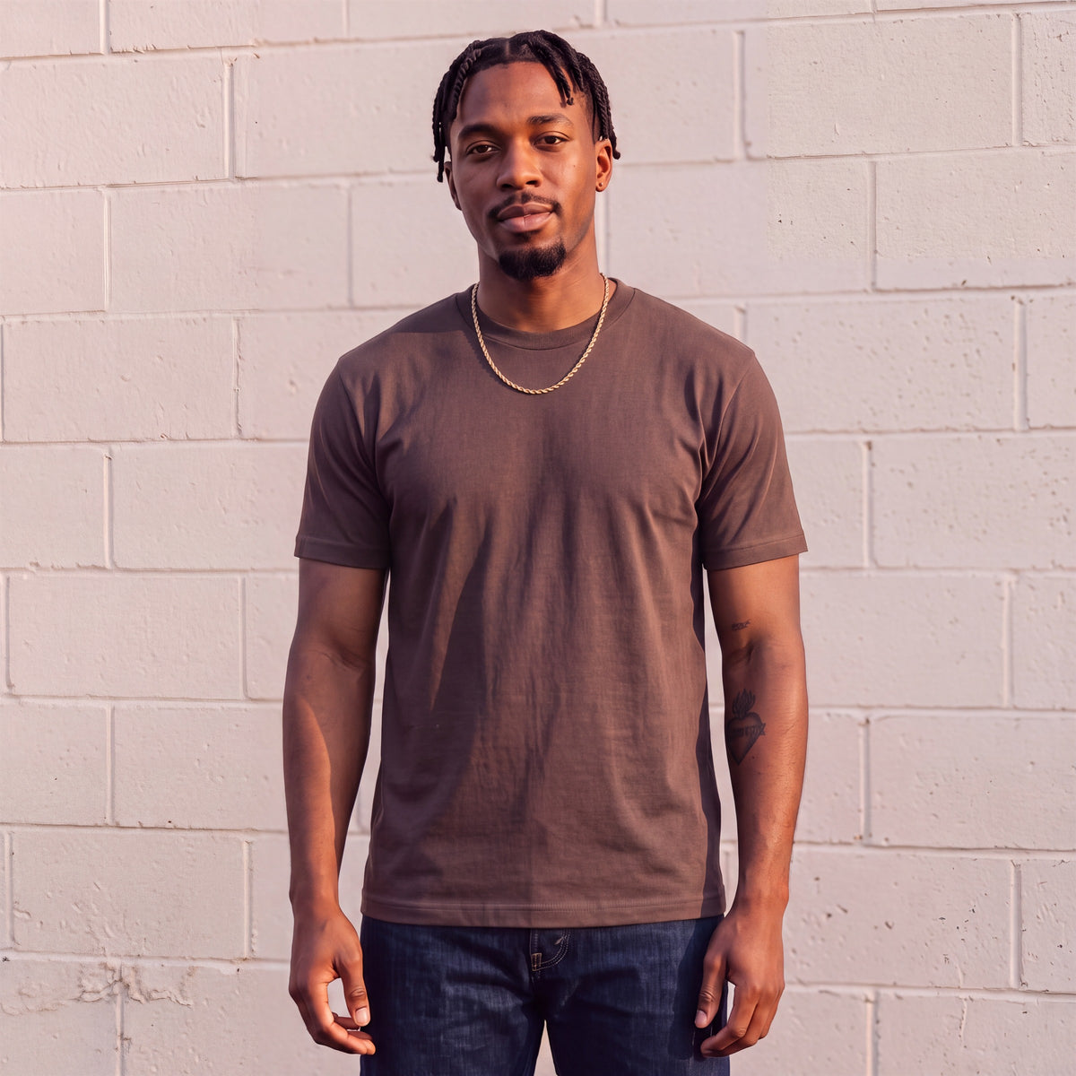 Model wearing Shaka Wear 6.0 oz Active Short Sleeve T-Shirt in Brown