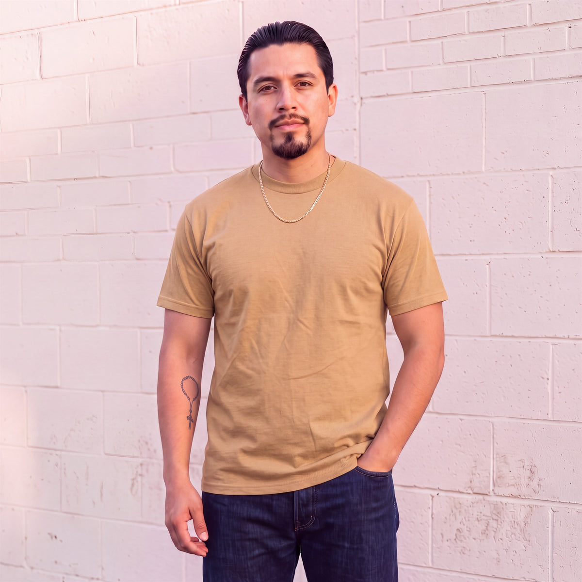 Model wearing Shaka Wear 6.0 oz Active Short Sleeve T-Shirt in Khaki