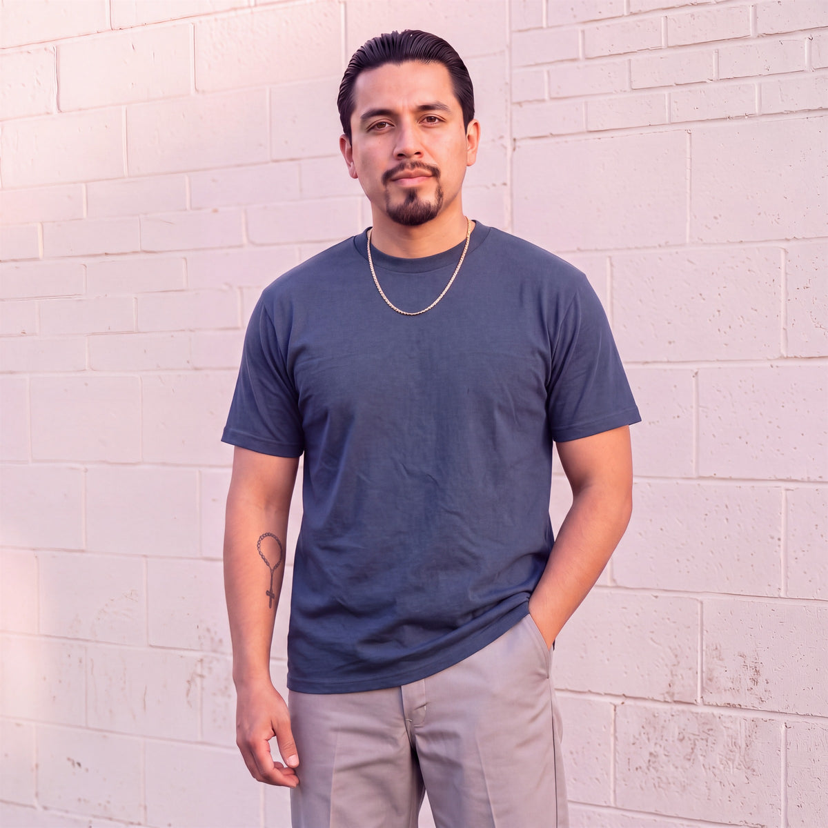 Model wearing Shaka Wear 6.0 oz Active Short Sleeve T-Shirt in Navy
