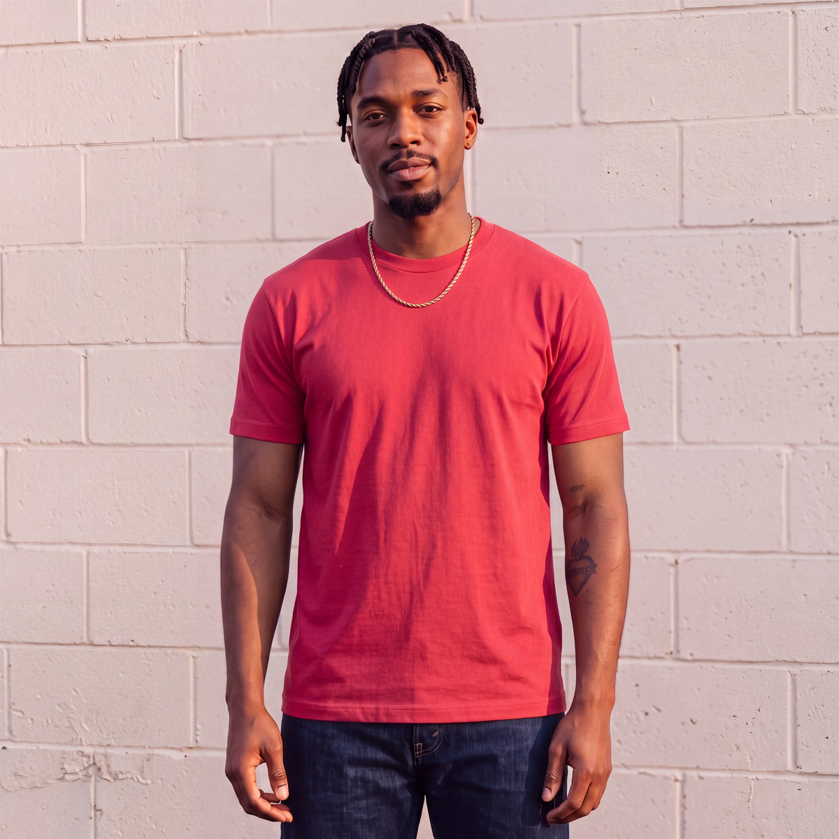 Model wearing Shaka Wear 6.0 oz Active Short Sleeve T-Shirt in Red