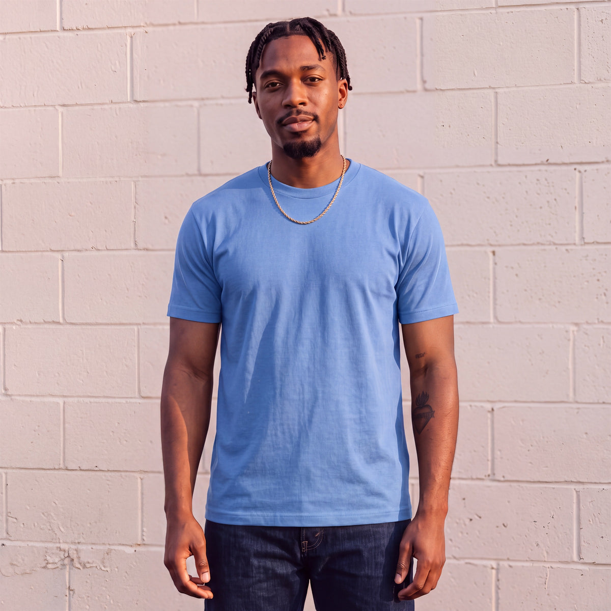 Model wearing Shaka Wear 6.0 oz Active Short Sleeve T-Shirt in Sky Blue