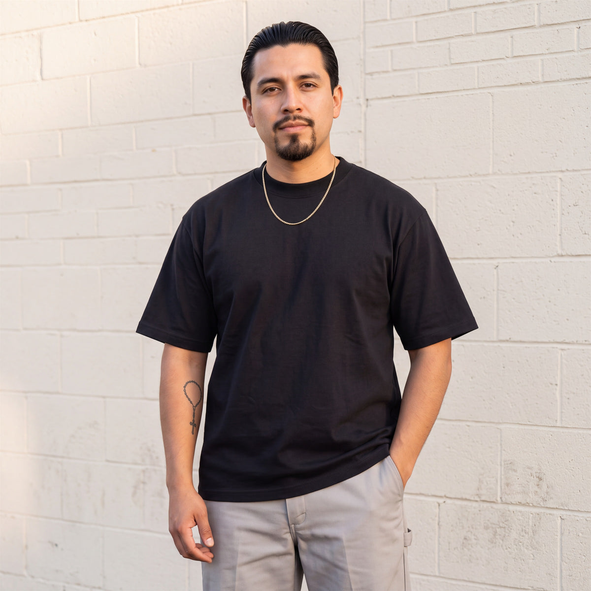 Model wearing Shaka Wear 7.5 oz Max Heavyweight Short Sleeve T-Shirt in Black