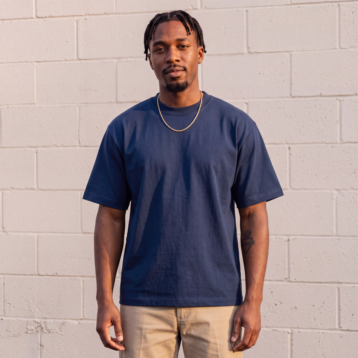 Model wearing Shaka Wear 7.5 oz Max Heavyweight Short Sleeve T-Shirt in Navy