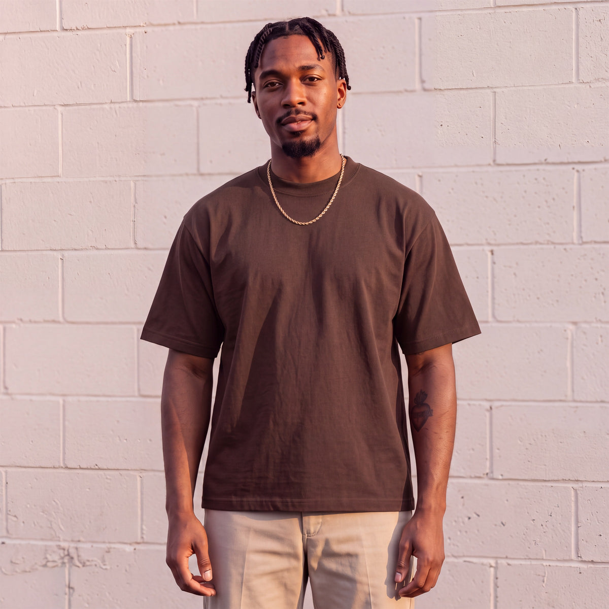 Model wearing Shaka Wear 7.5 oz Max Heavyweight Short Sleeve T-Shirt in Brown
