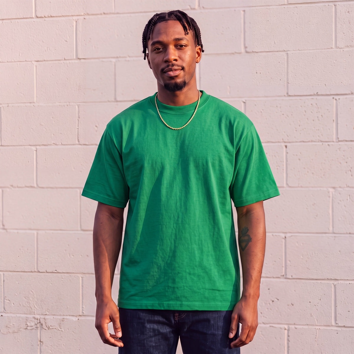 Model wearing Shaka Wear 7.5 oz Max Heavyweight Short Sleeve T-Shirt in Kelly Green