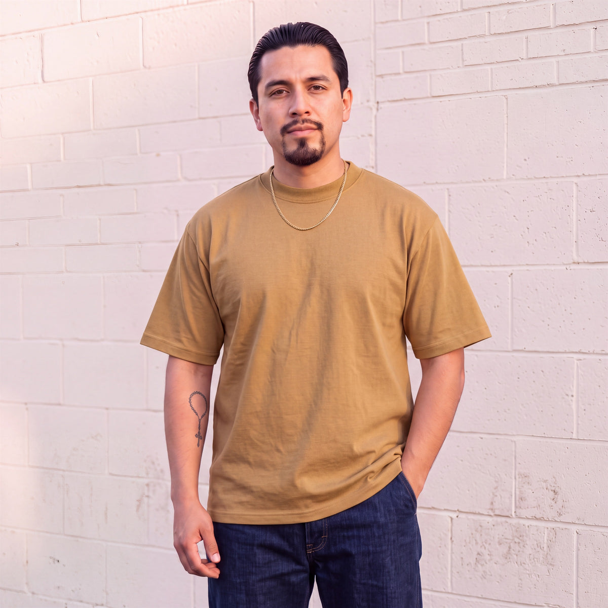 Model wearing Shaka Wear 7.5 oz Max Heavyweight Short Sleeve T-Shirt in Khaki