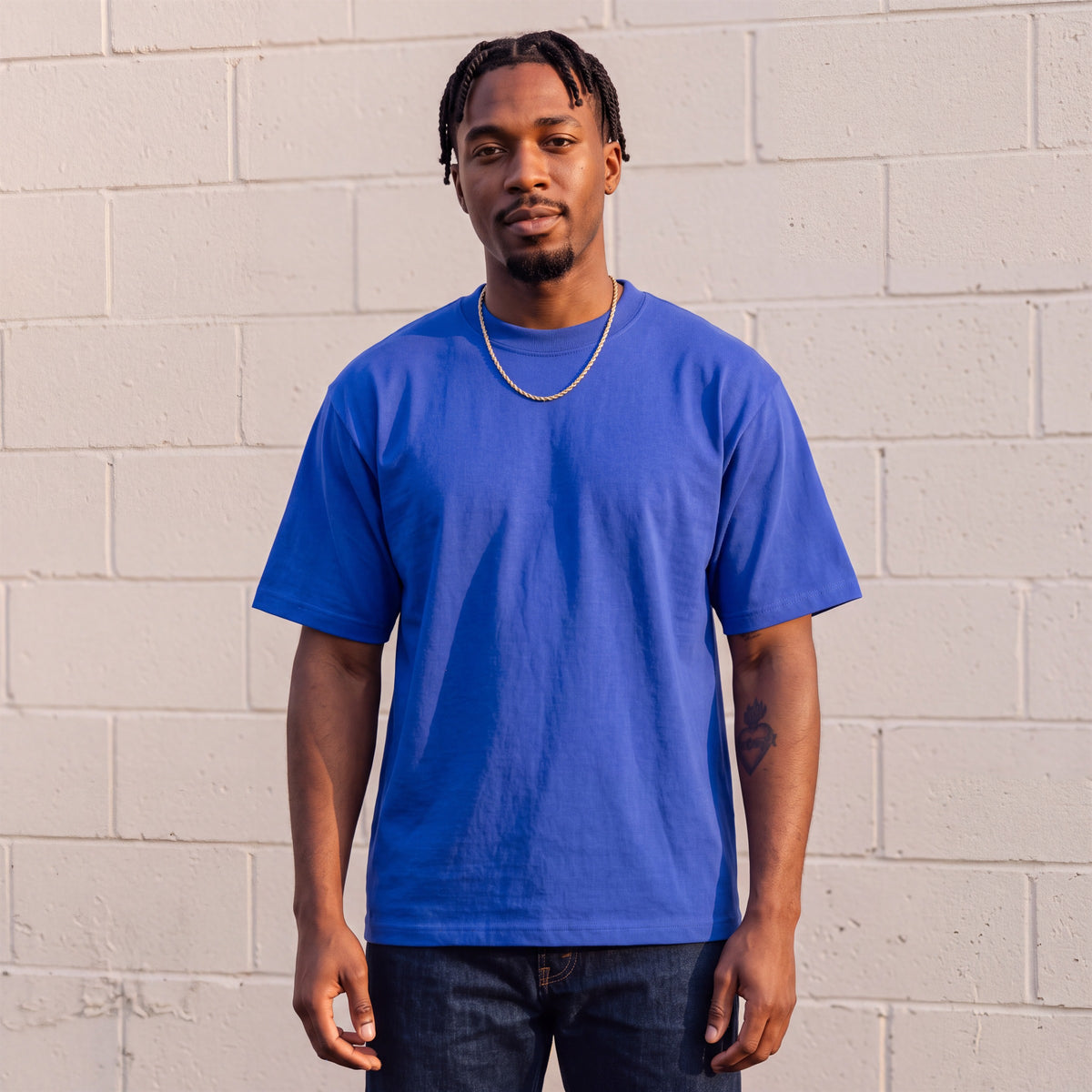 Model wearing Shaka Wear 7.5 oz Max Heavyweight Short Sleeve T-Shirt in Royal