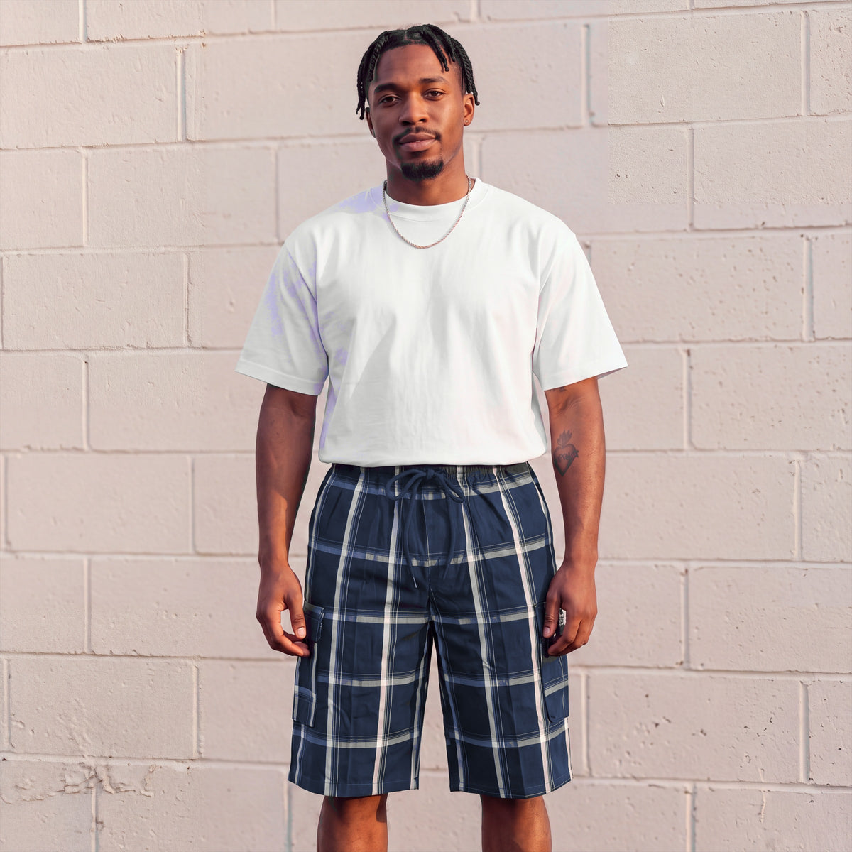 Model wearing Shaka Wear Plaid Shorts in Navy
