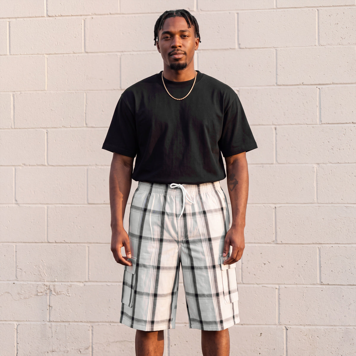 Model wearing Shaka Wear Plaid Shorts in White